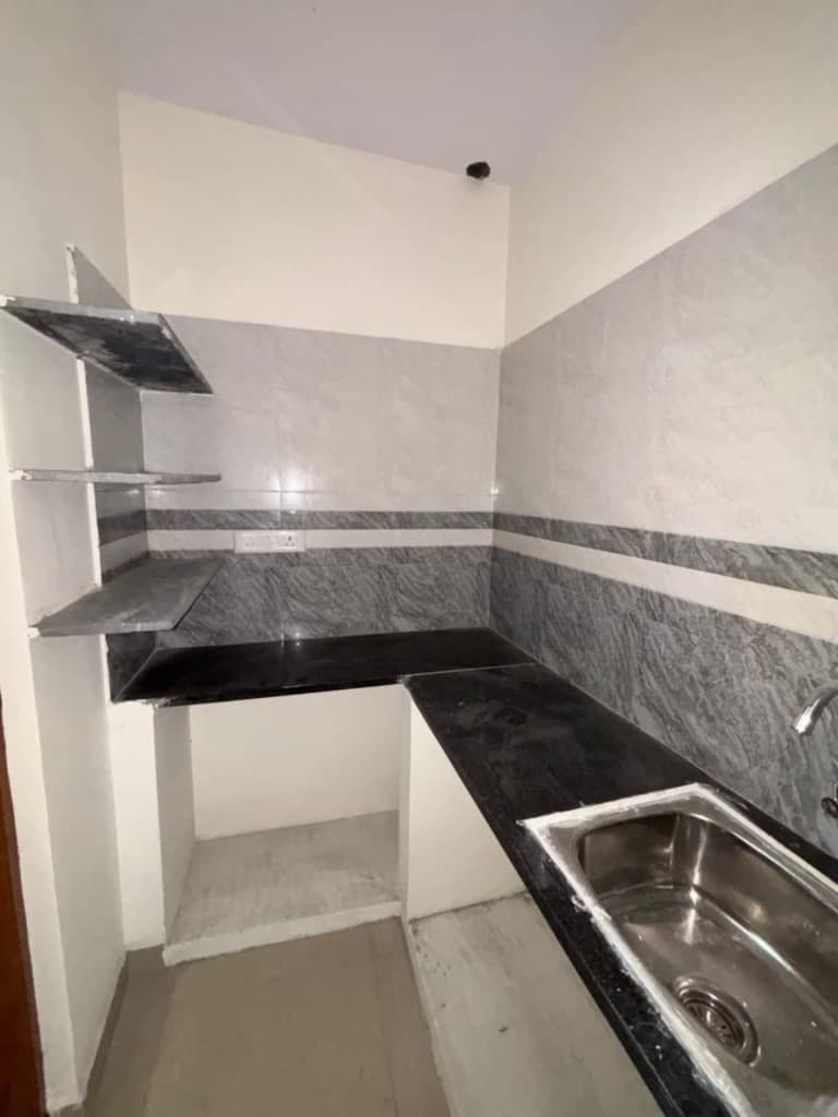 SLN Homes 1 BHK dedicated kitchen platform with sink and shelves